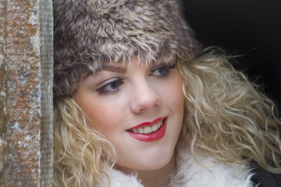 A portrait of a young lady wearing a fur hat.